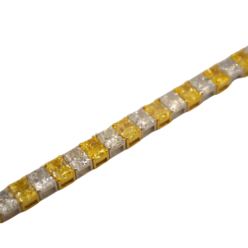 Elegantly crafted gold tennis bracelet with white and yellow diamonds.