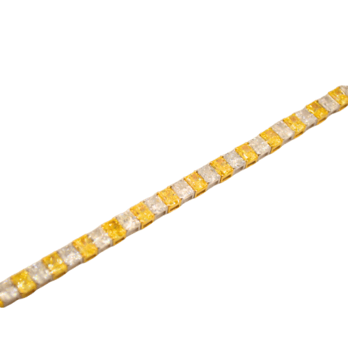 Elegantly crafted gold tennis bracelet with white and yellow diamonds.