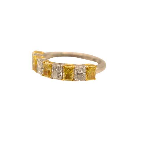 White and yellow diamond ring with elegant beaded design.